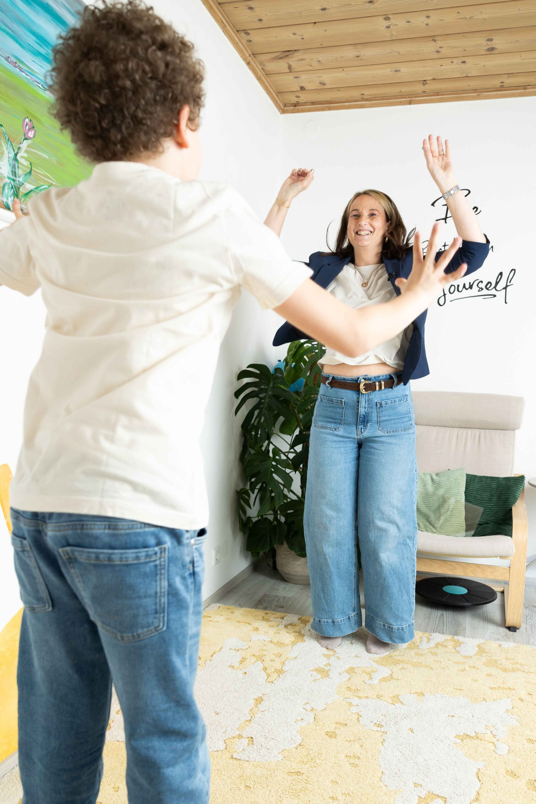 isi4you Trainerin fördert Konzentration durch bewegtes Lernen: Kind und Trainerin springen vor Freude beim Training